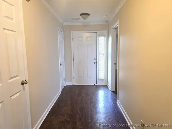 a view of a hallway with wooden floor