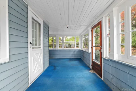 a view of hallway with wooden floor and furniture