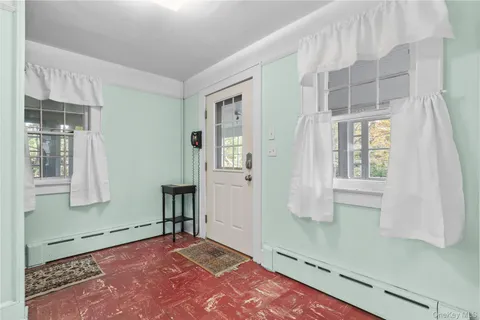 a view of an empty room with window and stairs