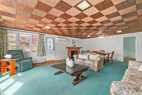 a living room with furniture and a floor to ceiling window