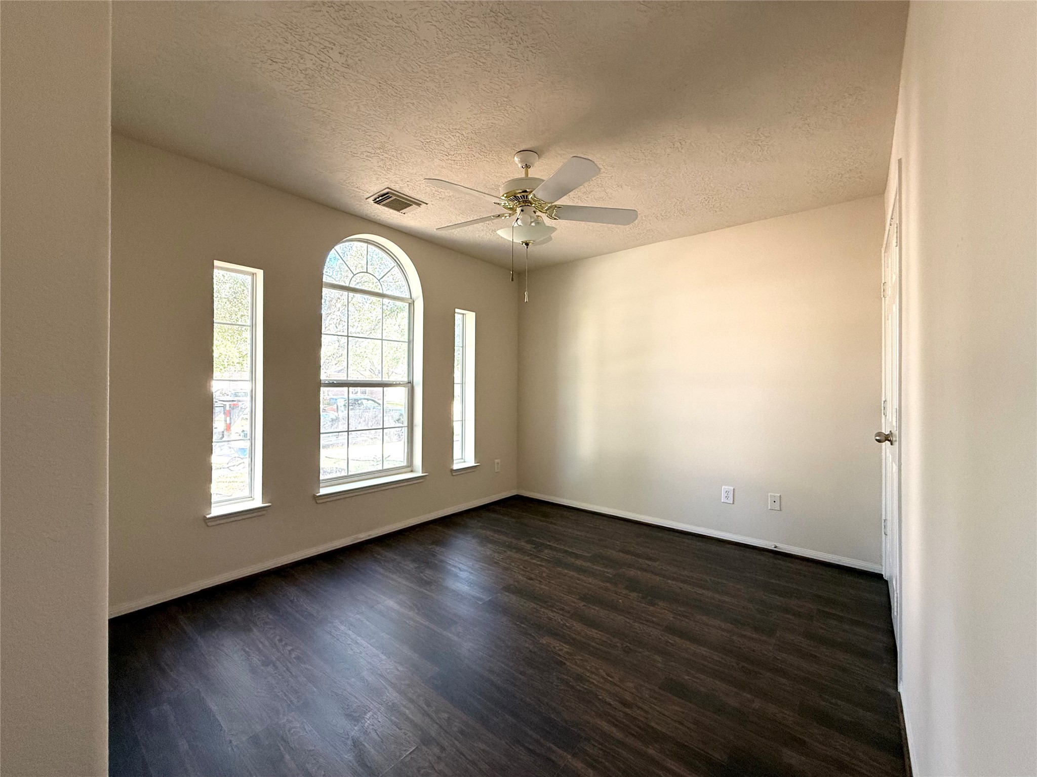 13102 Castlewind Lane Pearland, TX 77584 - Photo 15 of 31 Bedroom 2
Secondary bedroom featuring new flooring, fresh paint, and charming arched windows providing great natural light.