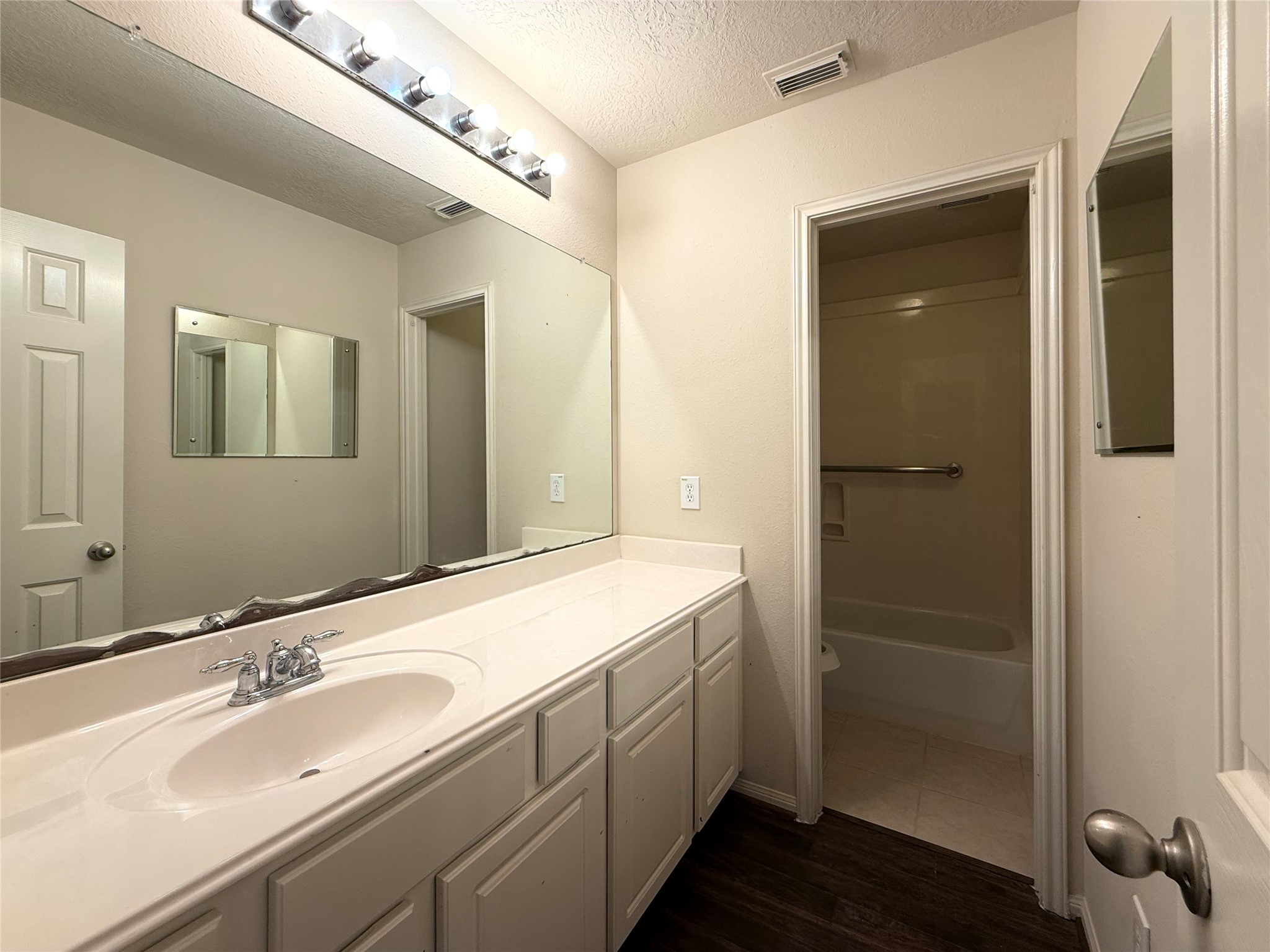 13102 Castlewind Lane Pearland, TX 77584 - Photo 21 of 31 Full bathroom with a long vanity, ample cabinet storage, and bright lighting.