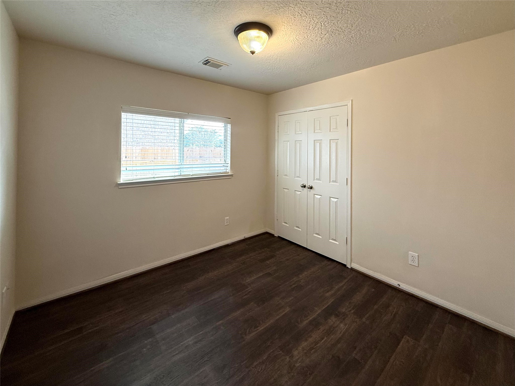 13102 Castlewind Lane Pearland, TX 77584 - Photo 23 of 31 Bedroom 3
Secondary bedroom featuring new flooring, fresh paint, and a window for natural light.