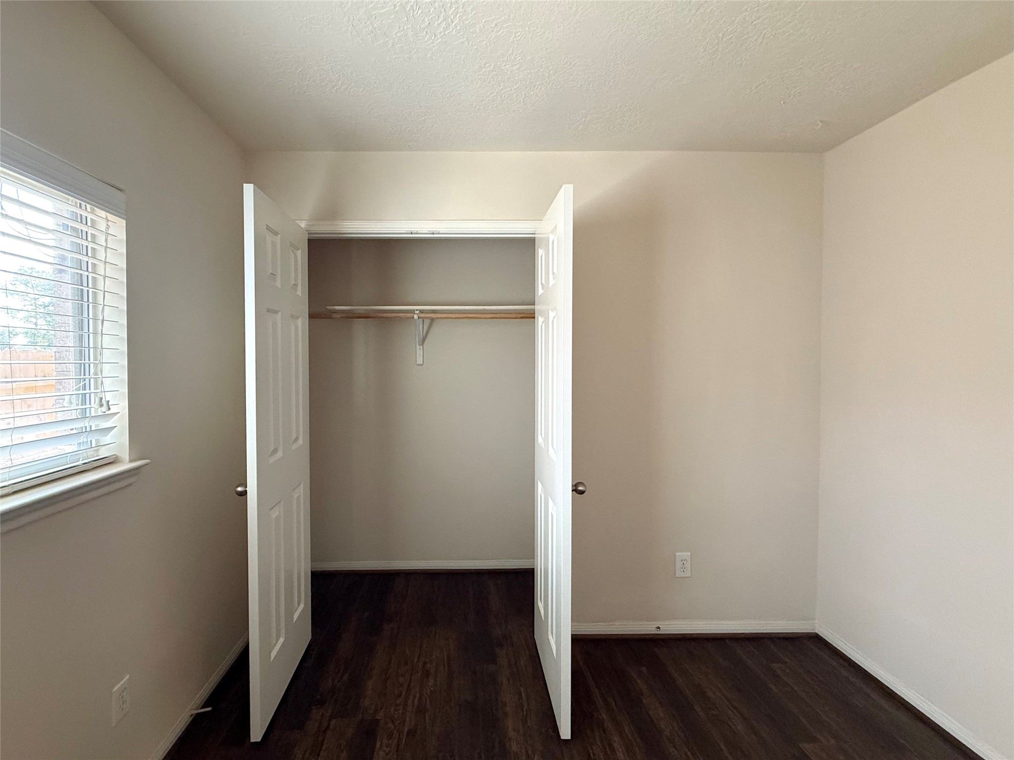 13102 Castlewind Lane Pearland, TX 77584 - Photo 24 of 31 Secondary bedroom closet with double doors and easy-access storage.