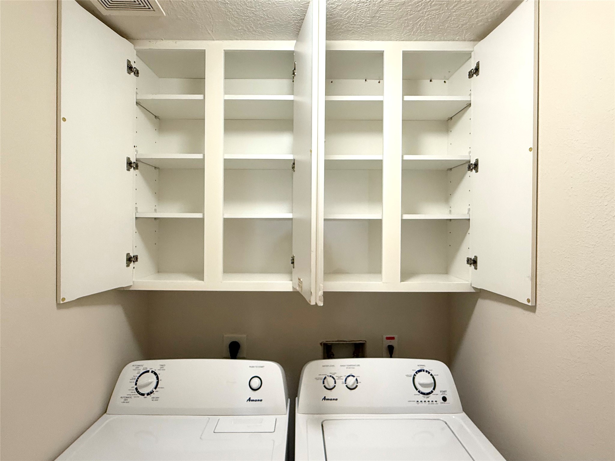13102 Castlewind Lane Pearland, TX 77584 - Photo 26 of 31 Another view of the laundry area showcasing the spacious upper cabinets for extra organization.