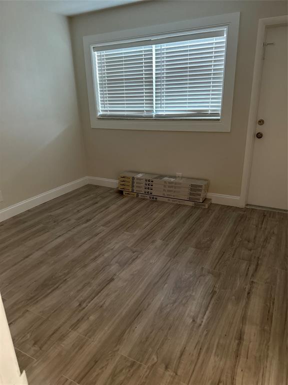 941 Crystal Lake Drive, Unit 201 Deerfield Beach, FL 33064 - Photo 18 of 27 a room with wooden floor and windows