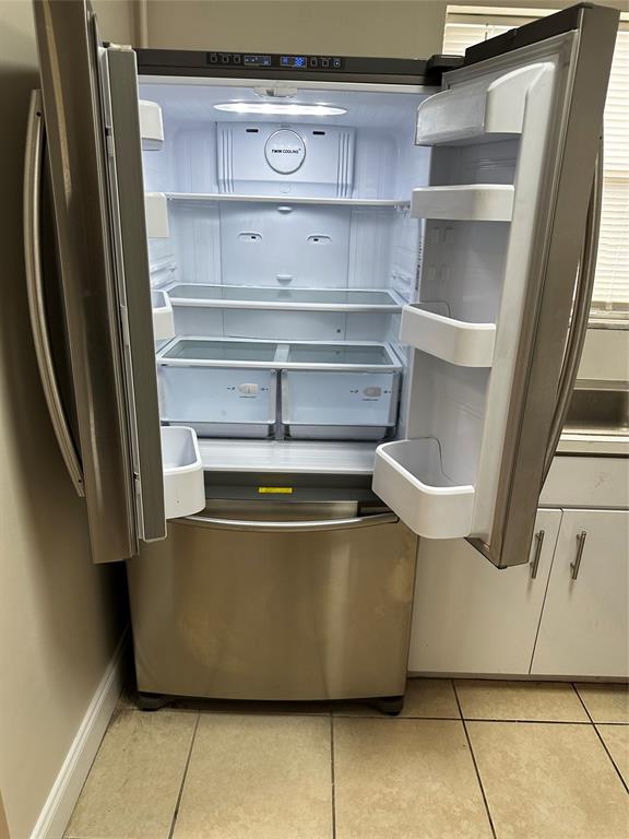 941 Crystal Lake Drive, Unit 201 Deerfield Beach, FL 33064 - Photo 3 of 27 a view of a refrigerator in a kitchen