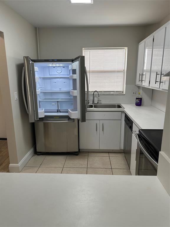 941 Crystal Lake Drive, Unit 201 Deerfield Beach, FL 33064 - Photo 6 of 27 a kitchen with stainless steel appliances a refrigerator sink and cabinets
