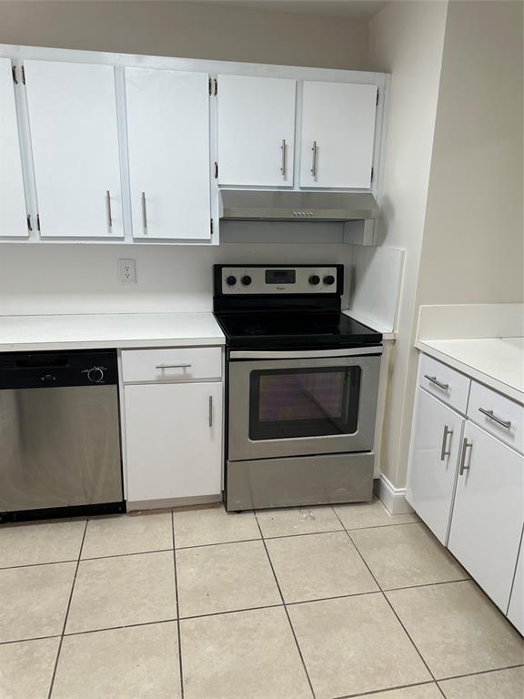 941 Crystal Lake Drive, Unit 201 Deerfield Beach, FL 33064 - Photo 7 of 27 a kitchen with white cabinets and appliances