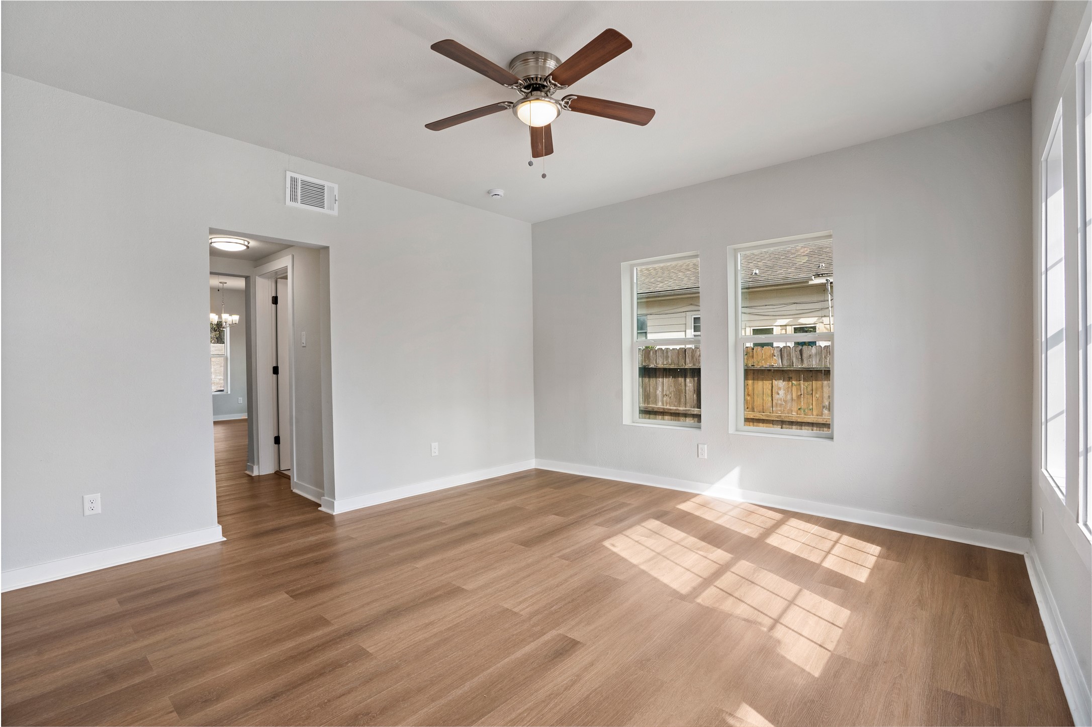 1115 Hogan Street, Unit 1 Houston, TX 77009 - Photo 4 of 12 a view of an empty room with window and wooden floor