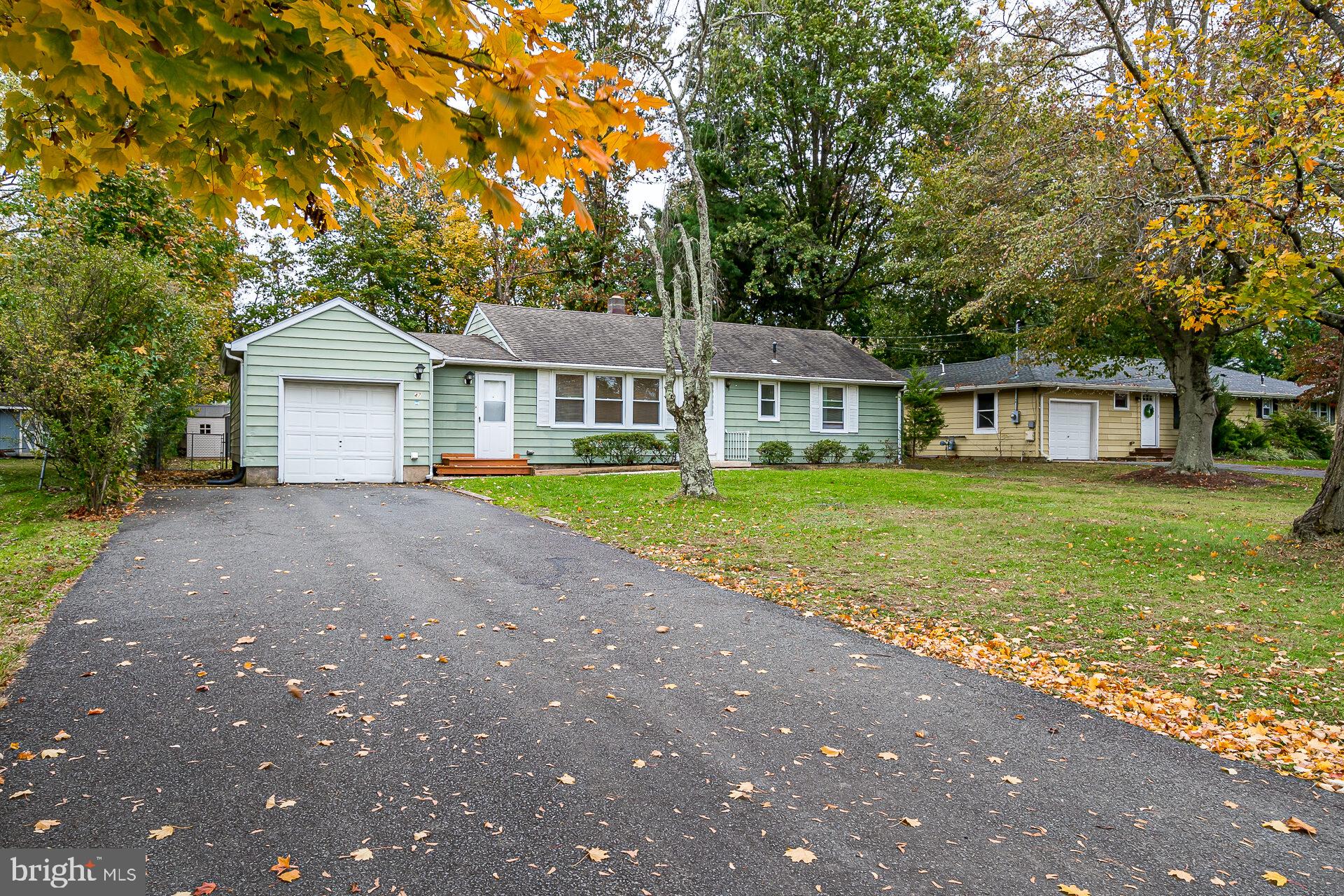47 Wallace Road Princeton Junction, NJ 08550 - Photo 1 of 27 a front view of a house with a garden and trees