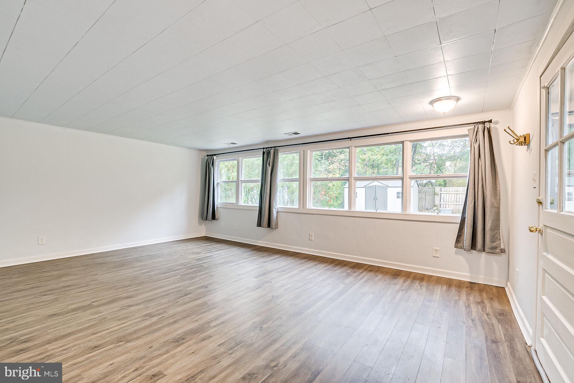 47 Wallace Road Princeton Junction, NJ 08550 - Photo 12 of 27 a view of an empty room with wooden floor and a window