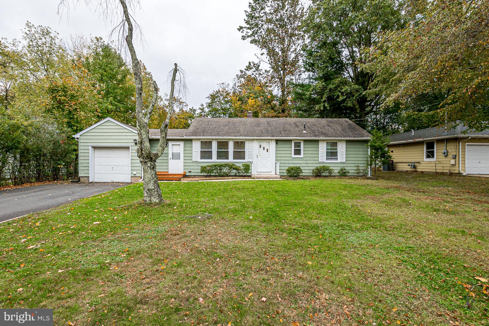 47 Wallace Road Princeton Junction, NJ 08550 - Photo 26 of 27 a front view of a house with a yard and trees