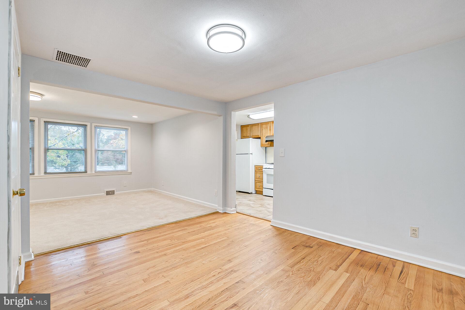 47 Wallace Road Princeton Junction, NJ 08550 - Photo 7 of 27 an empty room with wooden floor and windows