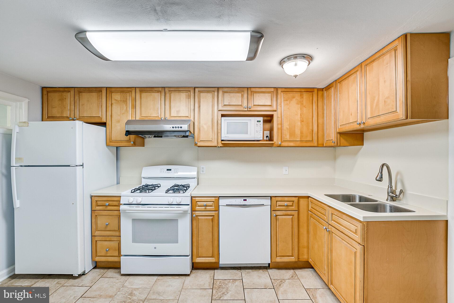 47 Wallace Road Princeton Junction, NJ 08550 - Photo 8 of 27 a kitchen with a stove a sink and a refrigerator
