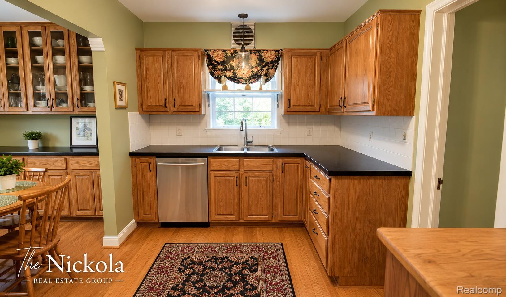 515 Barrington Road Detroit, MI 48215 - Photo 9 of 27 Kitchen with wood finish cabinets, a chandelier, dark countertops, and dishwasher