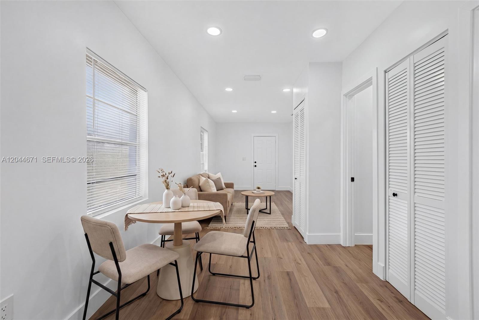1900 Southwest 6th Street, Unit 6 Miami, FL 33135 - Photo 3 of 20 a view of a dining room with furniture and wooden floor