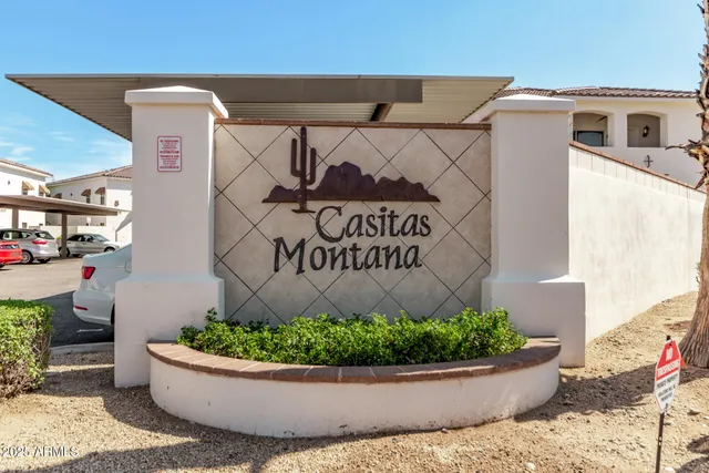 a view of sign board with potted plants