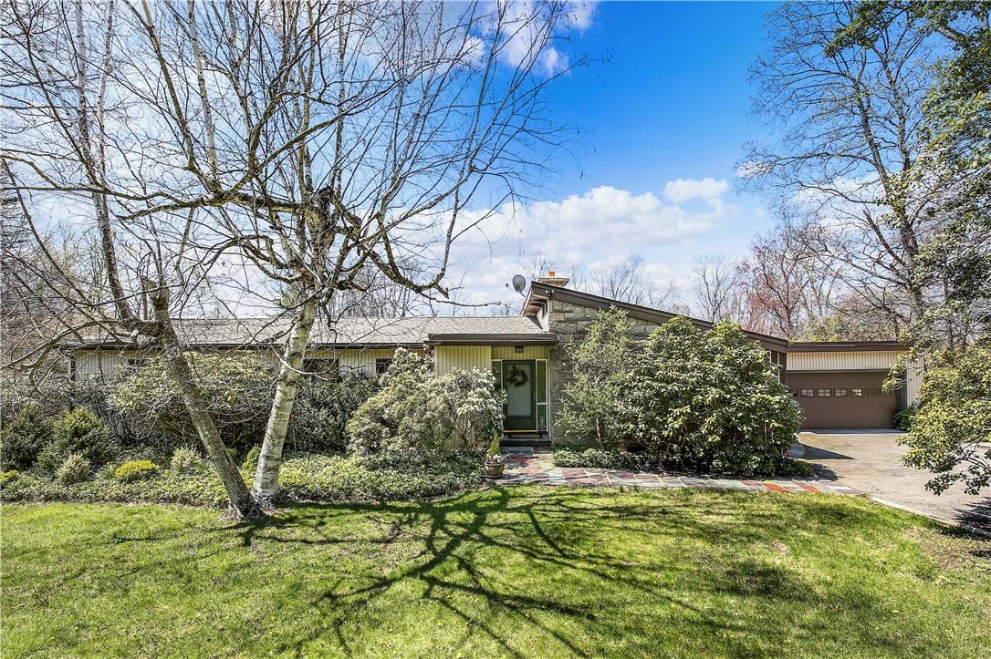 Mid Century Ranch, with stone and wood facade on 1.5 acres.