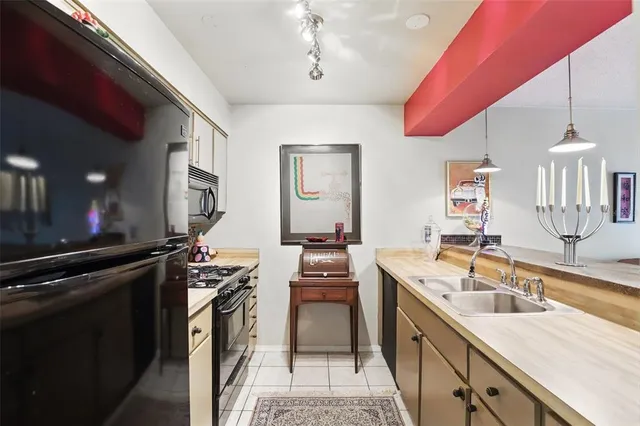 a kitchen with a sink stove and cabinets