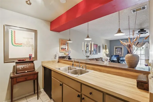 a kitchen with a sink a stove and chairs