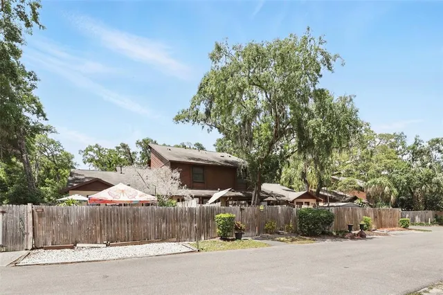 a view of a patio with table and chairs under an umbrella