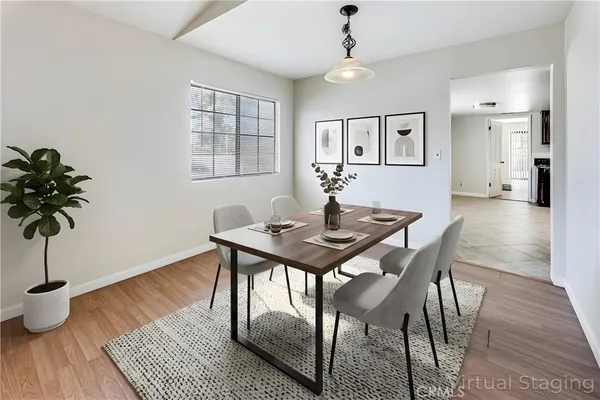 a view of a dining room with furniture and wooden floor