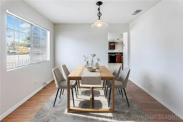 a view of a dining room with furniture window and wooden floor