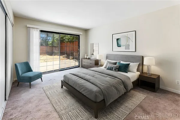 a bedroom with a large bed and a couch