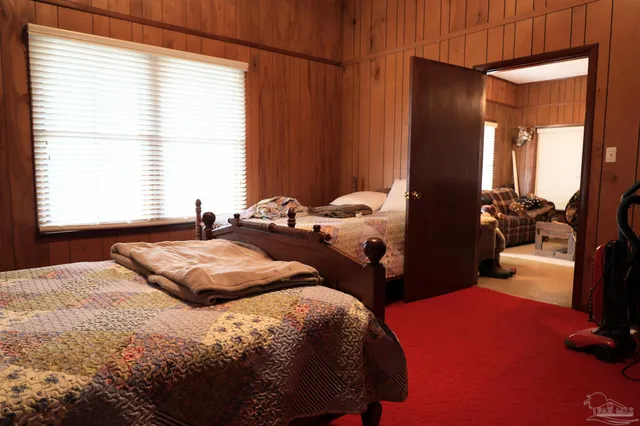 a bedroom with a bed and window