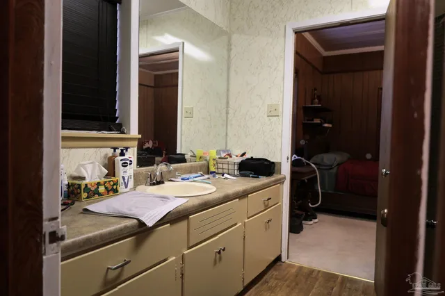 a bathroom with a sink a toilet and mirror
