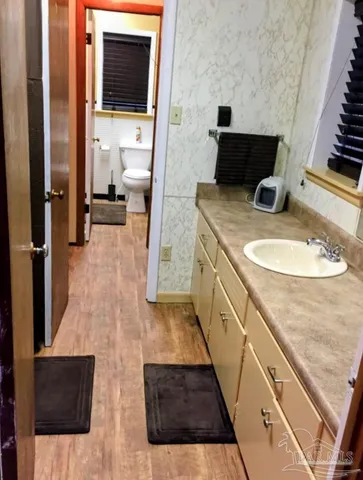 a view of a patio with table and chairs under an umbrella