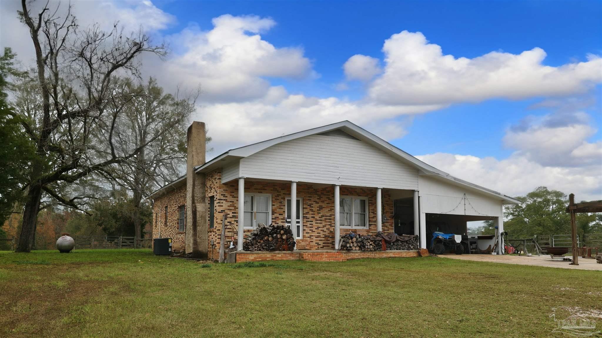 9023 County Road Millry, AL 36558 - Photo 24 of 72 a view of a house with a yard and garage