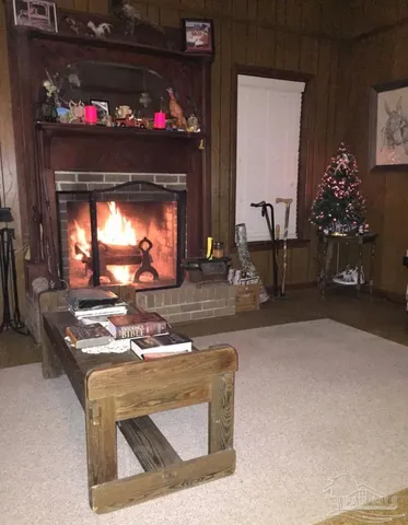 a living room with furniture a fireplace and a potted plant