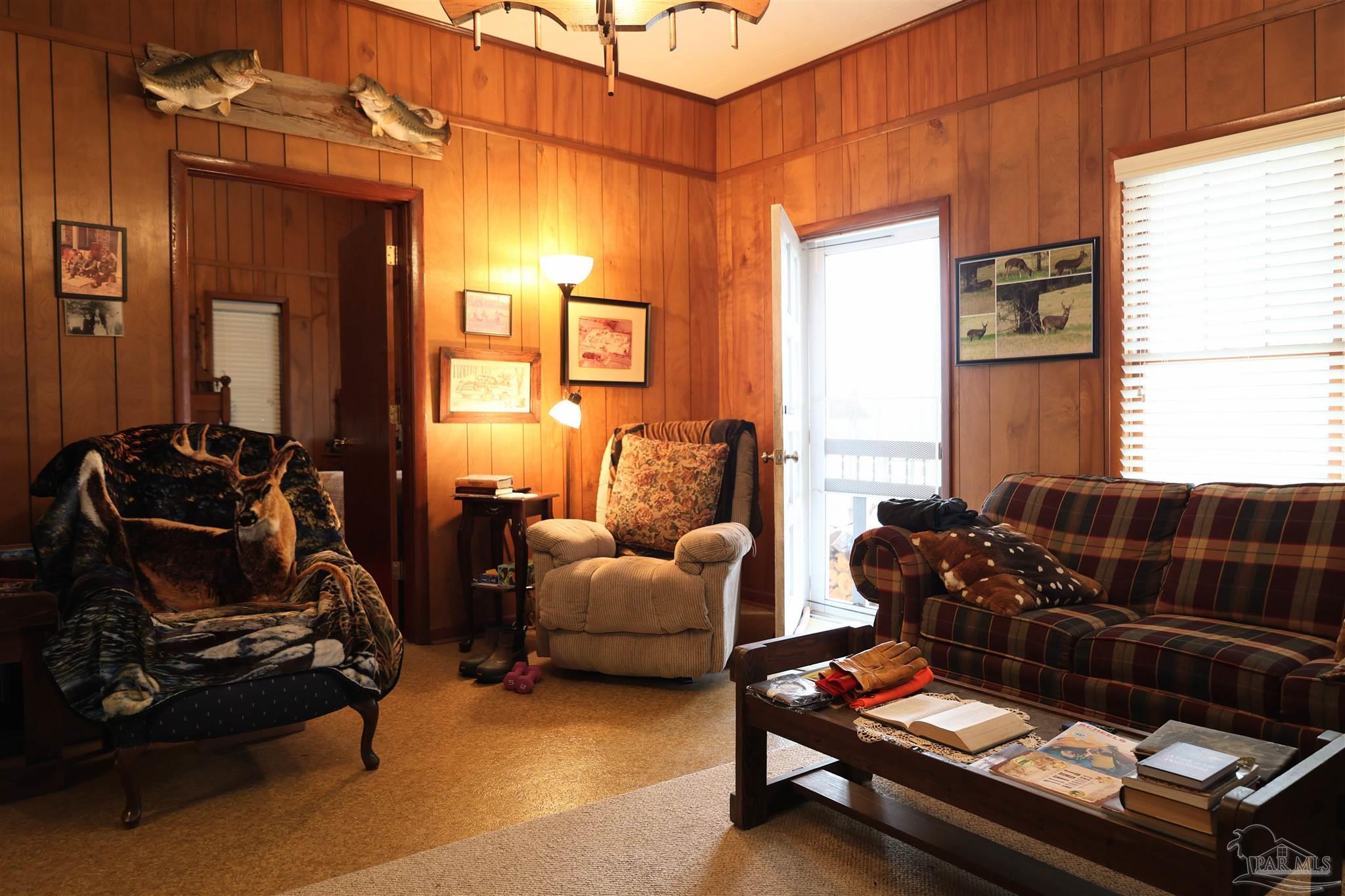 9023 County Road Millry, AL 36558 - Photo 9 of 72 a living room with furniture gym equipment and a window