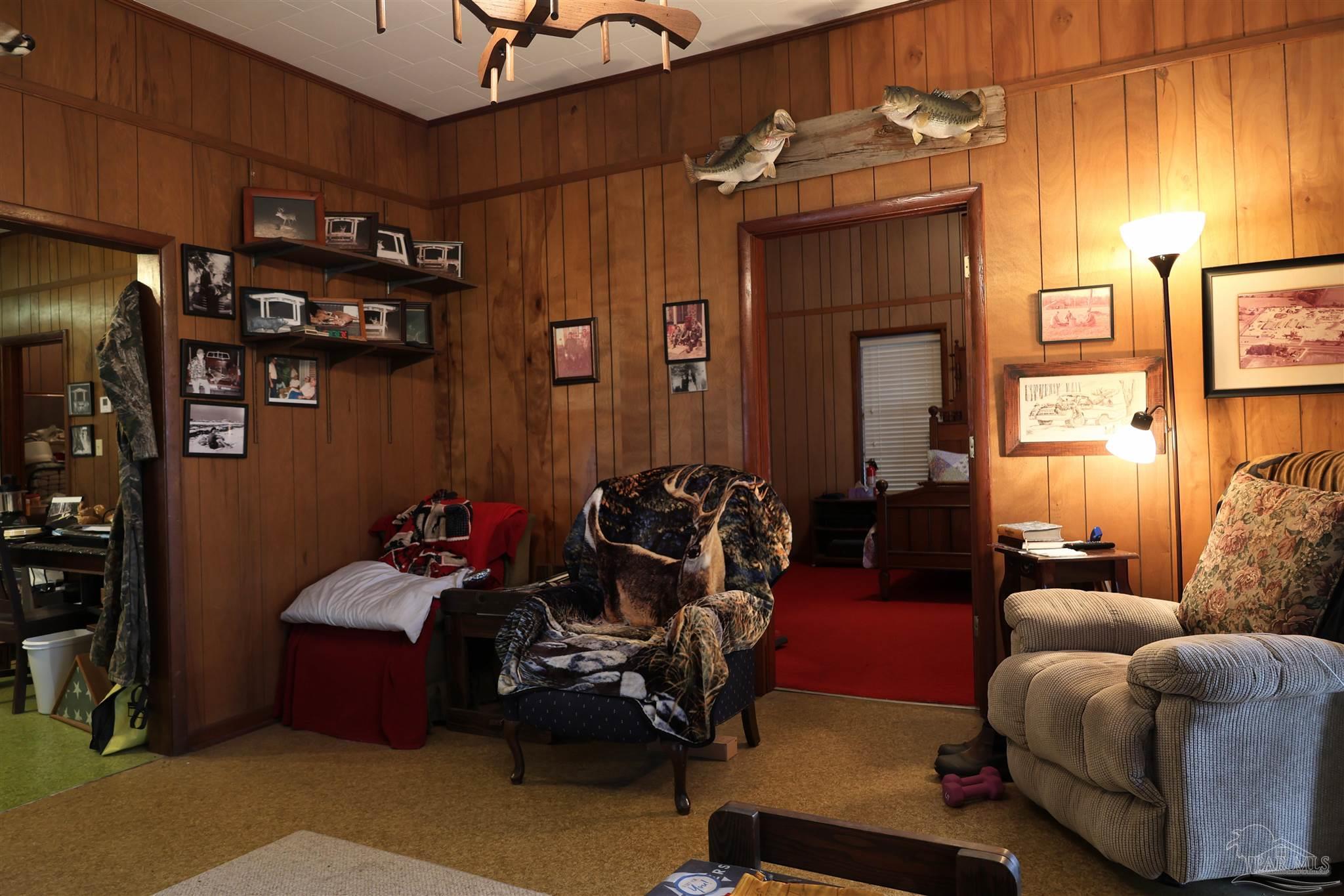 9023 County Road Millry, AL 36558 - Photo 10 of 72 a room with furniture toys and a chandelier