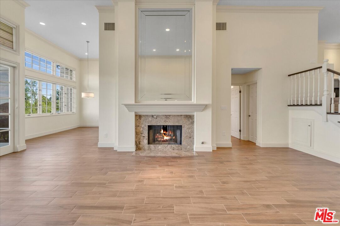 2202 The Terrace Los Angeles, CA 90049 - Photo 11 of 40 a view of a livingroom with a fireplace wooden floor and window