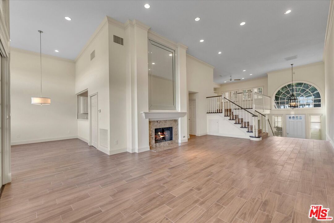 2202 The Terrace Los Angeles, CA 90049 - Photo 12 of 40 a view of a hallway with wooden floor and a kitchen