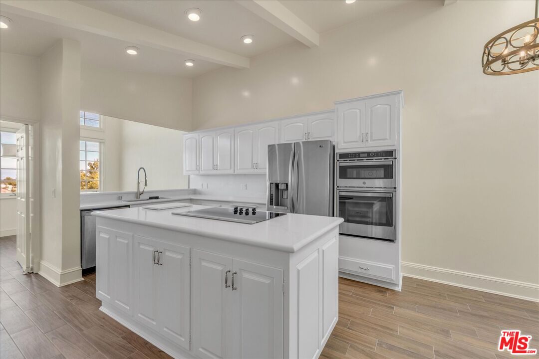 2202 The Terrace Los Angeles, CA 90049 - Photo 16 of 40 a kitchen with a sink a refrigerator and cabinets