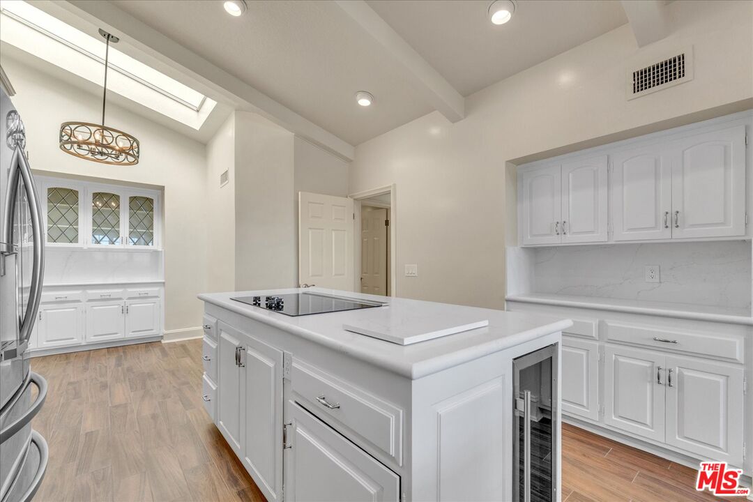 2202 The Terrace Los Angeles, CA 90049 - Photo 18 of 40 a kitchen that has a sink a stove and cabinets