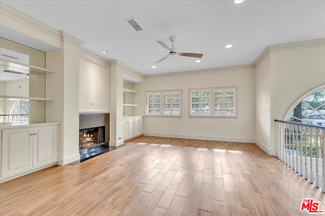 2202 The Terrace Los Angeles, CA 90049 - Photo 26 of 40 an empty room with windows and fireplace