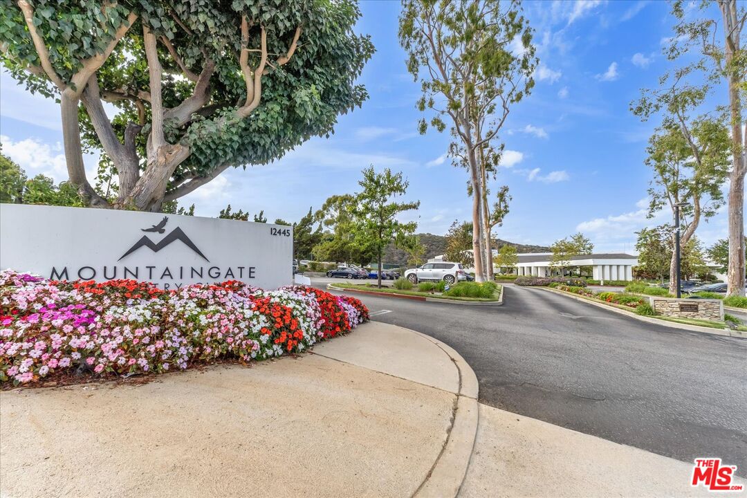 2202 The Terrace Los Angeles, CA 90049 - Photo 3 of 40 a view of a garden with a table and potted plants