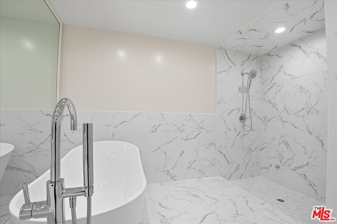 2202 The Terrace Los Angeles, CA 90049 - Photo 33 of 40 a bathroom with a bathtub and shower