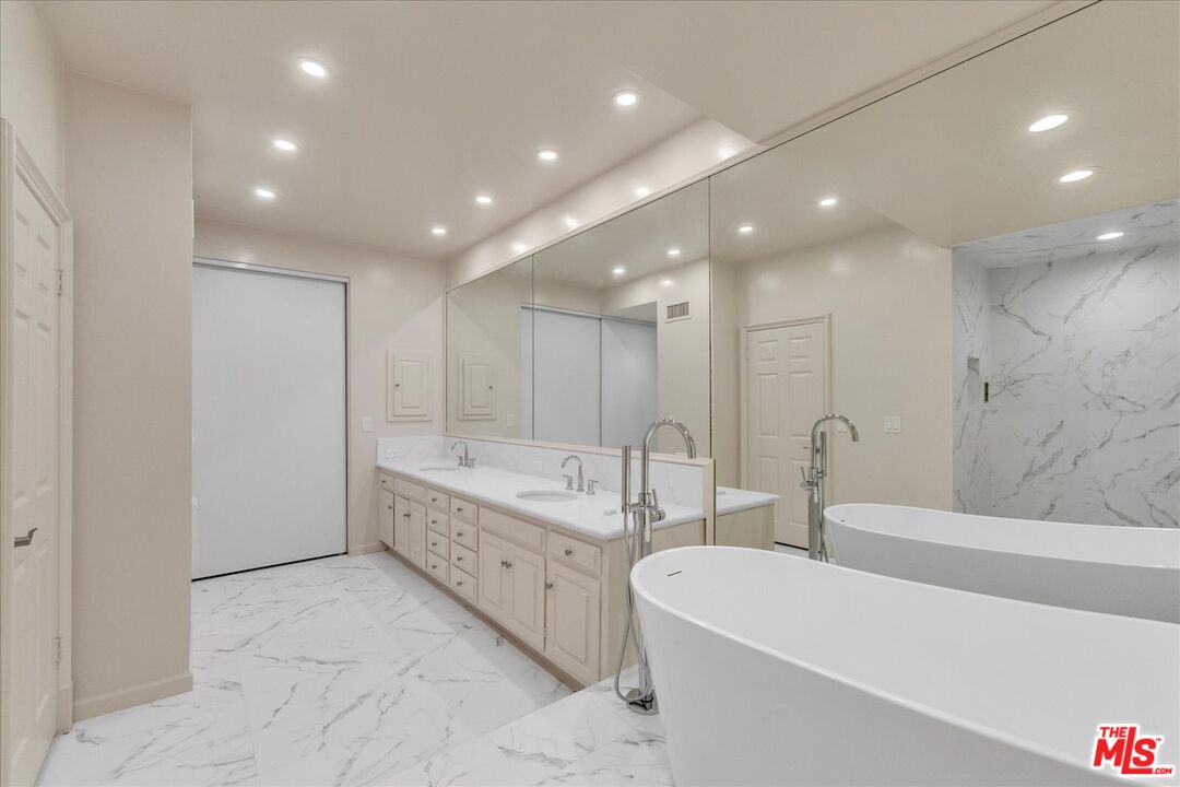 2202 The Terrace Los Angeles, CA 90049 - Photo 34 of 40 a large bathroom with a large tub a vanity and a sink