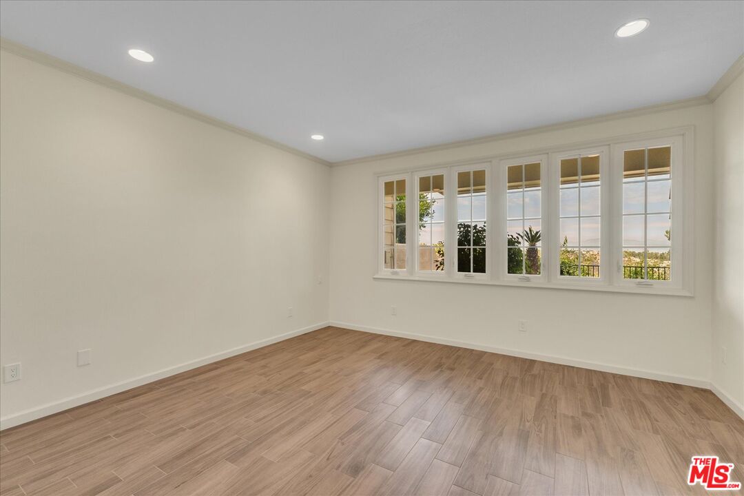 2202 The Terrace Los Angeles, CA 90049 - Photo 35 of 40 a view of an empty room with wooden floor and a window