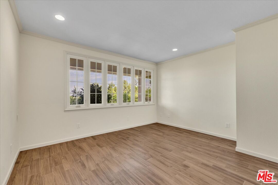 2202 The Terrace Los Angeles, CA 90049 - Photo 36 of 40 a view of an empty room with wooden floor and a window