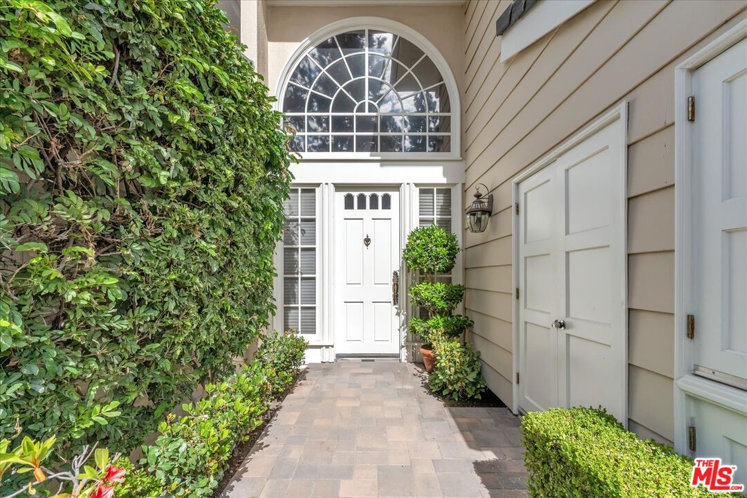 2202 The Terrace Los Angeles, CA 90049 - Photo 9 of 40 a front view of a house with a garden