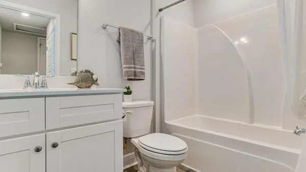 a bathroom with a sink toilet vanity and shower