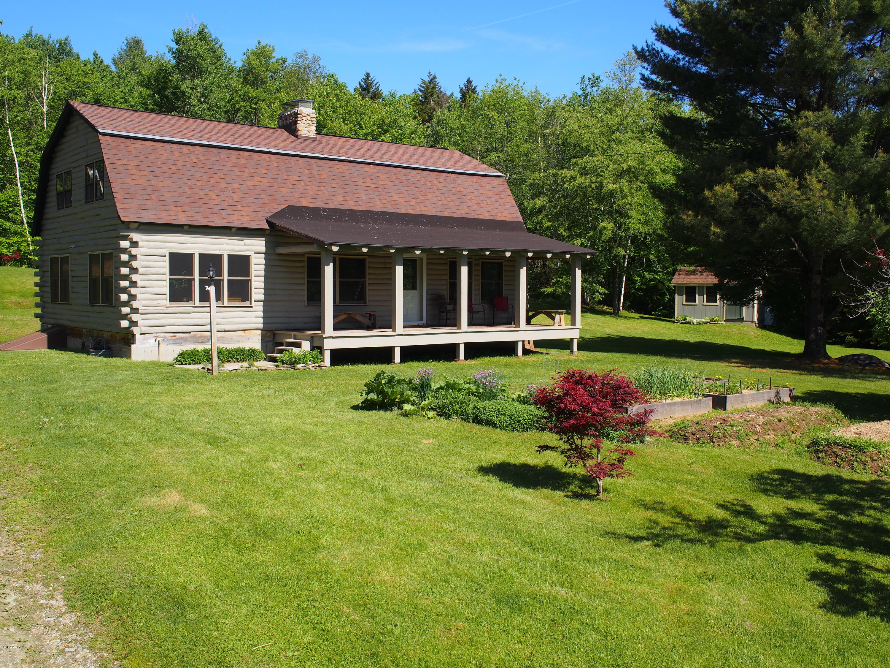 52 Central Shaft Road Florida, MA 01247 - Photo 1 of 31 a front view of a house with a yard table and chairs