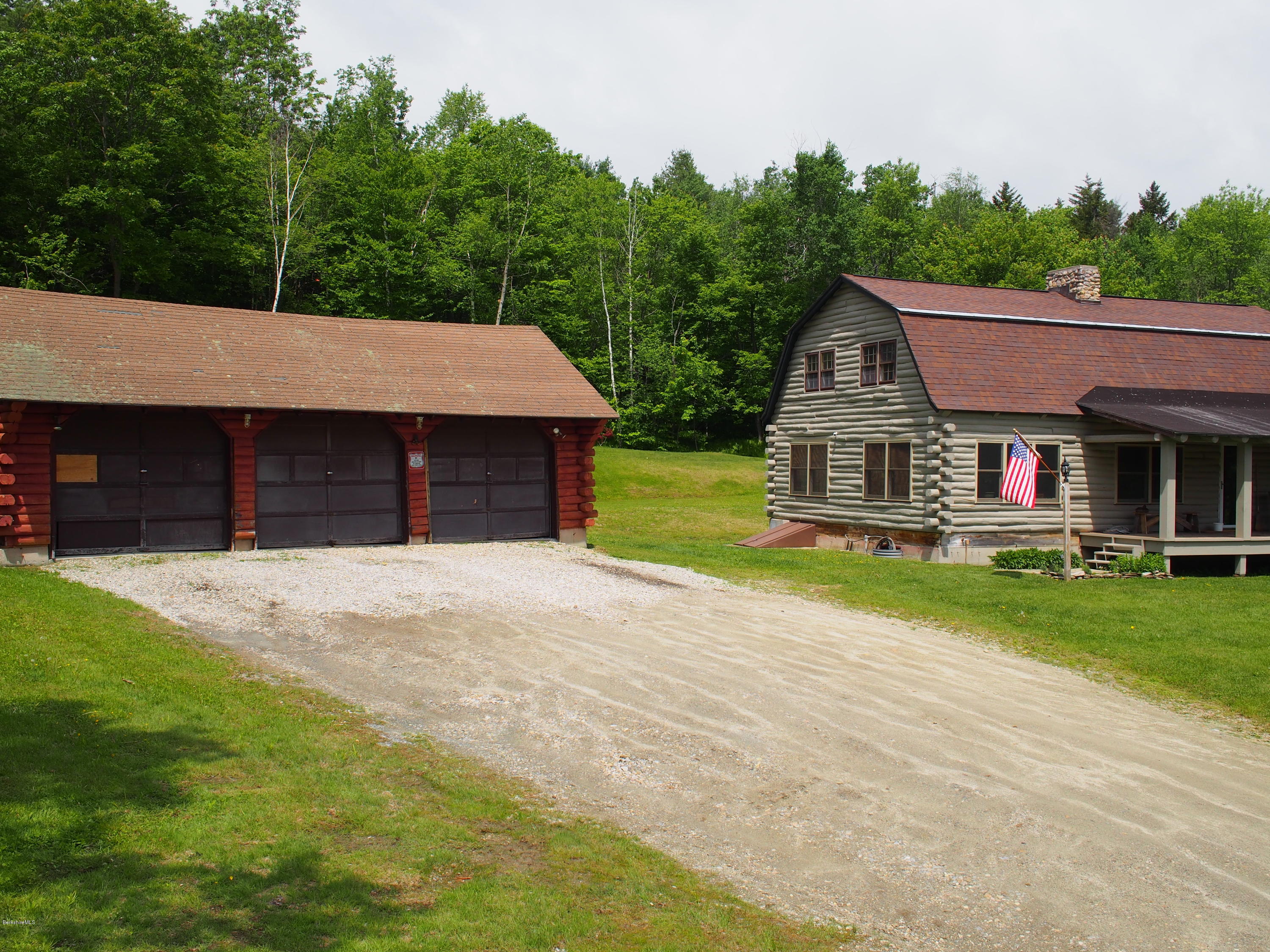 52 Central Shaft Road Florida, MA 01247 - Photo 2 of 31 a front view of a house with a yard and garage